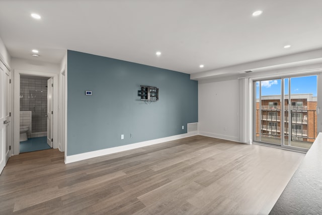 unfurnished room with light wood-type flooring