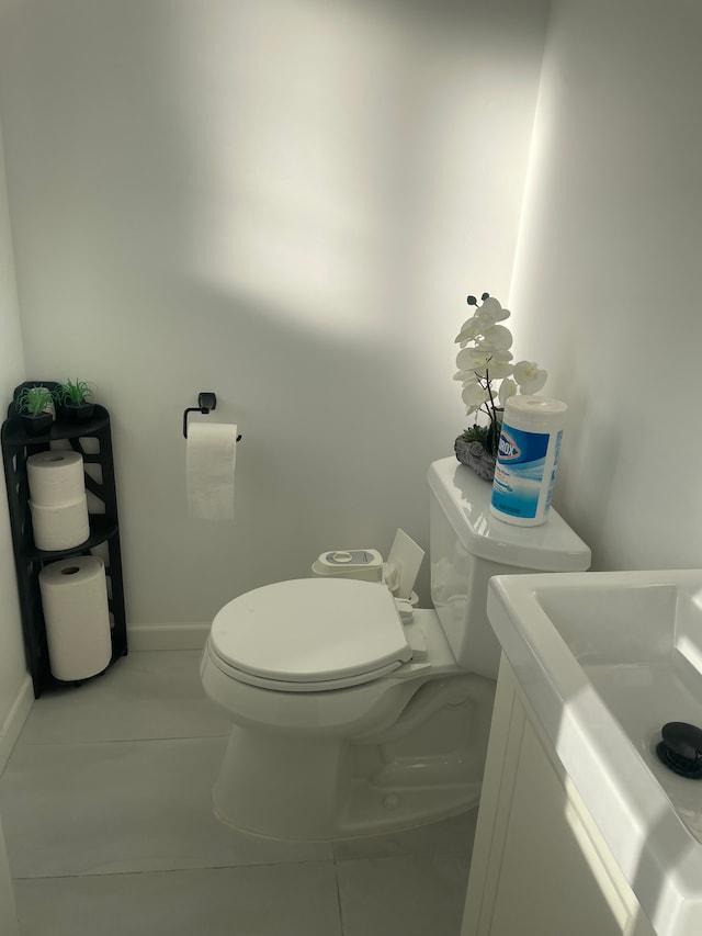 bathroom featuring tile patterned flooring, vanity, and toilet