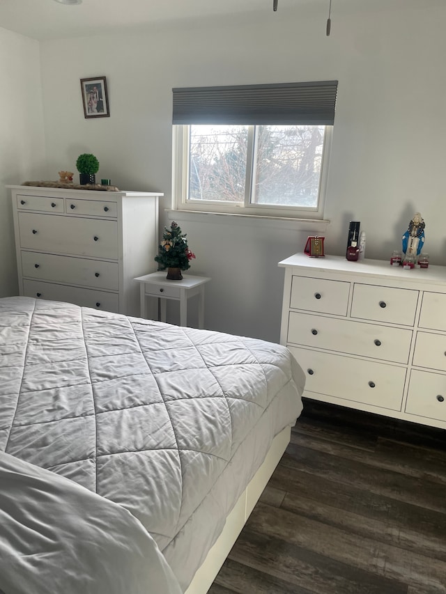 bedroom with dark hardwood / wood-style flooring