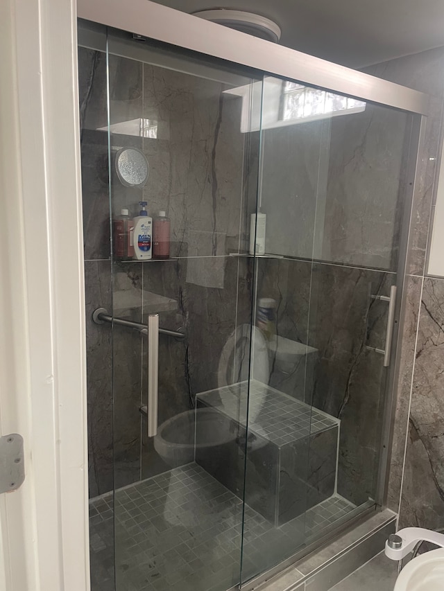 bathroom with a shower with shower door