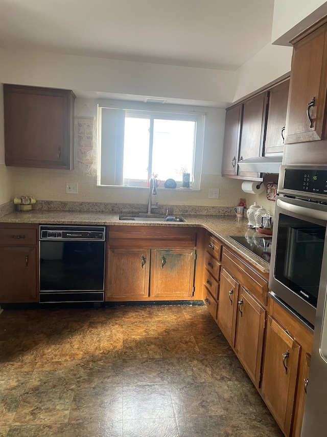 kitchen featuring black appliances, decorative backsplash, sink, and range hood