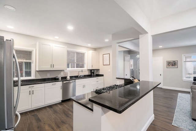 kitchen with sink, white cabinetry, stainless steel appliances, and dark wood-type flooring