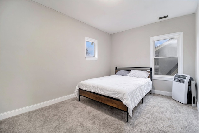 bedroom with light colored carpet