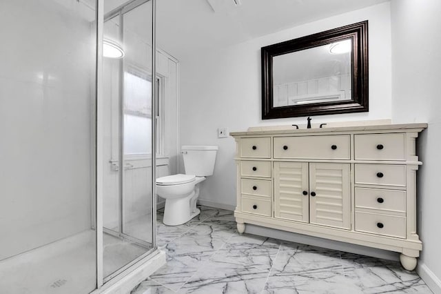 bathroom featuring vanity, toilet, and a shower with shower door