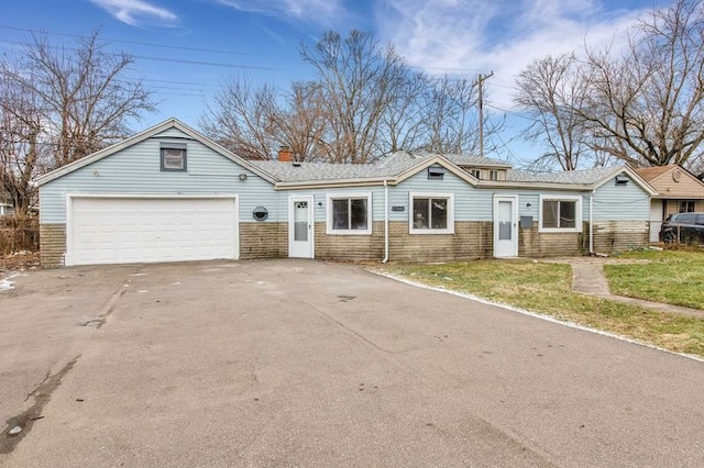 single story home with a front yard and a garage