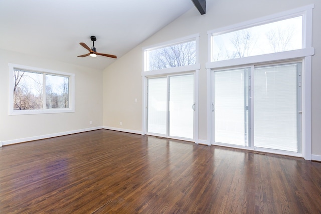 unfurnished living room with a wealth of natural light, ceiling fan, dark hardwood / wood-style flooring, and high vaulted ceiling