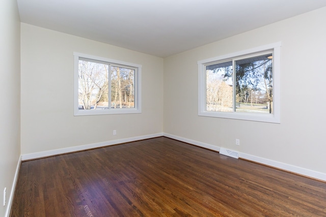 empty room with dark wood-type flooring