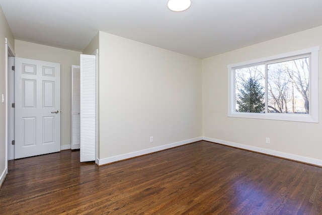 empty room featuring dark hardwood / wood-style flooring