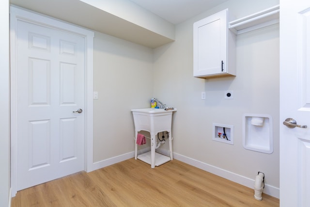 laundry room featuring electric dryer hookup, cabinets, light wood-type flooring, and hookup for a washing machine