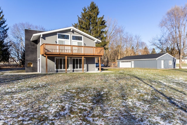 back of property with a wooden deck, an outdoor structure, and a garage