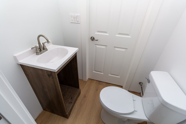 bathroom featuring vanity, wood-type flooring, and toilet