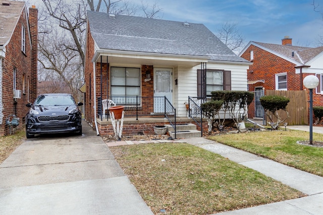 bungalow-style home featuring a porch and a front yard