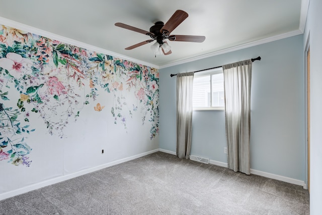 carpeted spare room featuring ceiling fan and ornamental molding