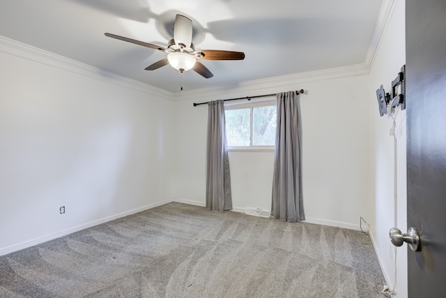 carpeted empty room featuring ceiling fan and ornamental molding