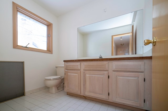 bathroom with tile patterned flooring, vanity, and toilet