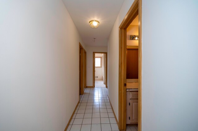 hall featuring light tile patterned floors