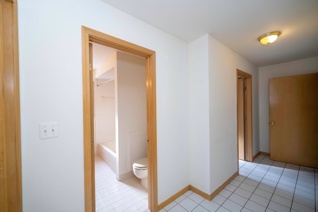 corridor featuring light tile patterned floors