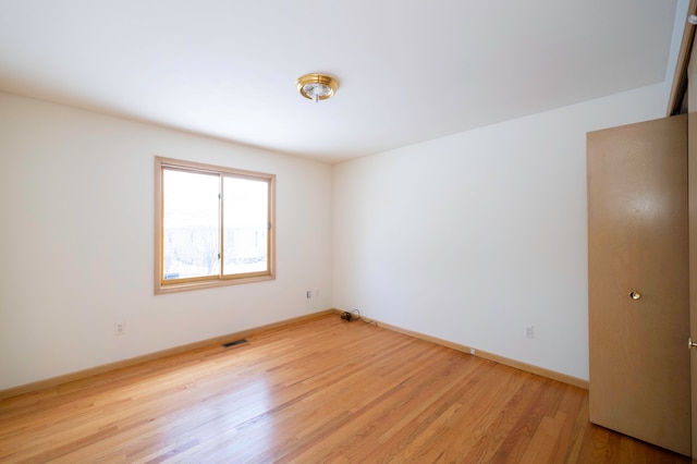 spare room featuring light hardwood / wood-style floors