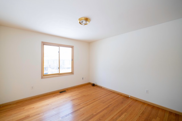 unfurnished room with light hardwood / wood-style floors