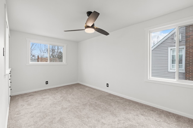 unfurnished room with ceiling fan and light colored carpet