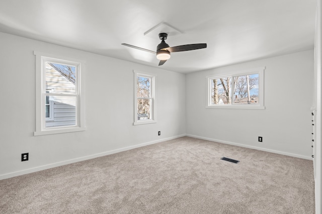 unfurnished room with ceiling fan and carpet