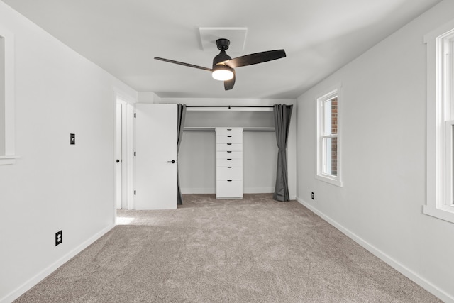 unfurnished bedroom featuring ceiling fan, light carpet, and a closet