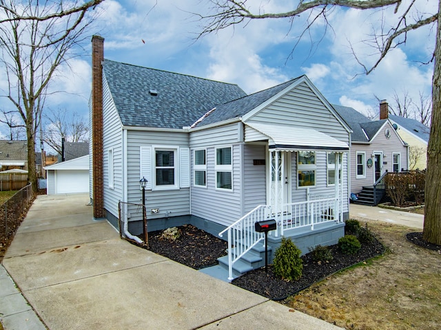 view of front facade featuring a garage and an outbuilding