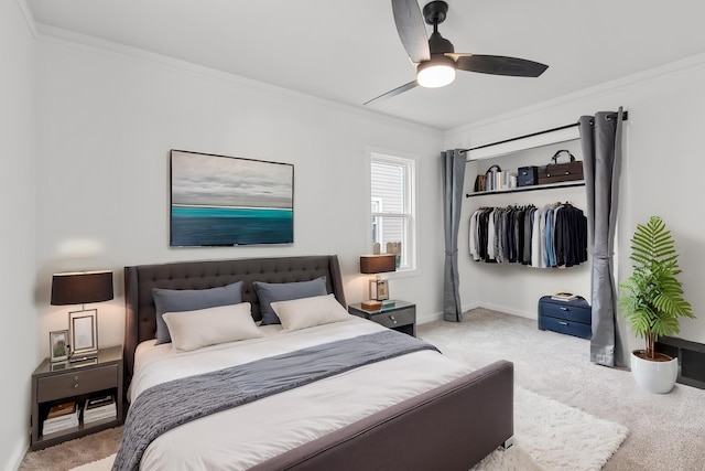 bedroom featuring ceiling fan, ornamental molding, light carpet, and a closet