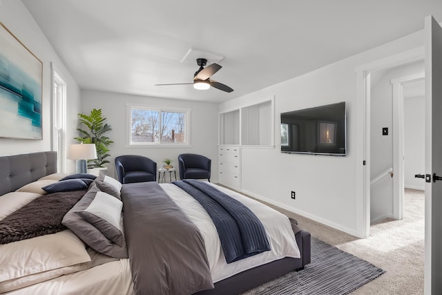 bedroom with ceiling fan and light carpet