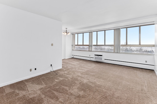 carpeted empty room featuring a baseboard radiator and a chandelier