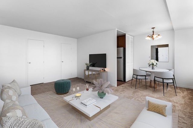 living room with a chandelier and carpet