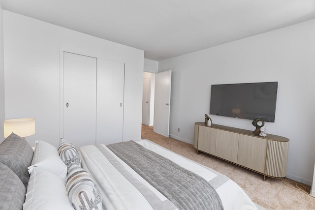 bedroom with light colored carpet and a closet