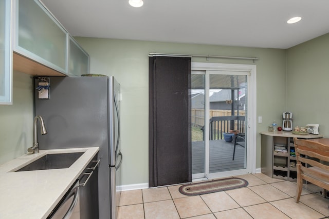 kitchen with light tile patterned floors and sink