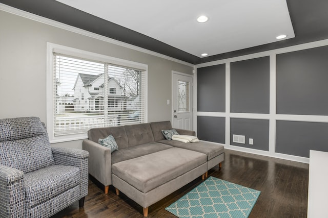 living room with crown molding and dark wood-type flooring