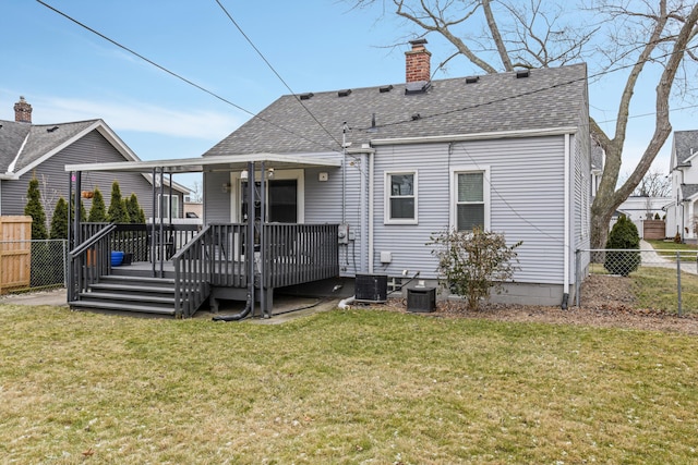 rear view of house featuring a yard, cooling unit, and a deck