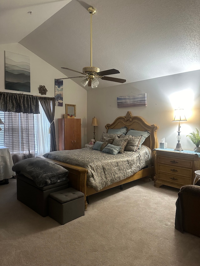 bedroom with a textured ceiling, ceiling fan, carpet floors, and lofted ceiling