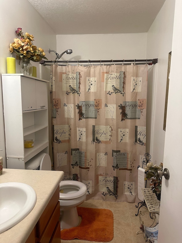 bathroom with vanity, tile patterned flooring, a shower with shower curtain, toilet, and a textured ceiling