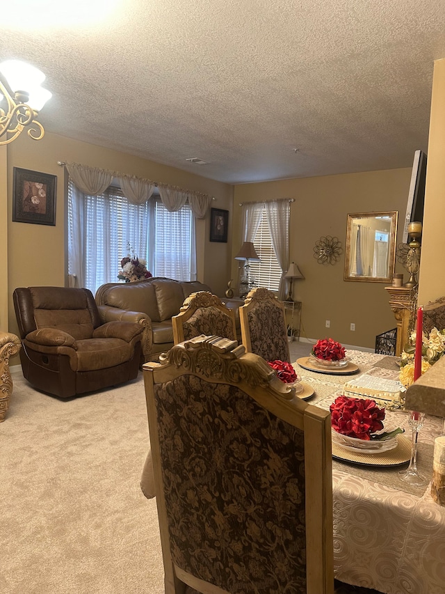 carpeted dining area with a textured ceiling