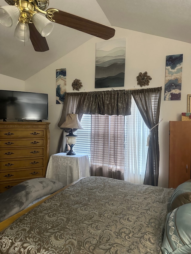 bedroom featuring ceiling fan and lofted ceiling