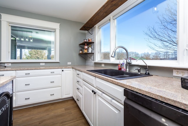 kitchen featuring dark wood-type flooring, dishwasher, white cabinets, and sink