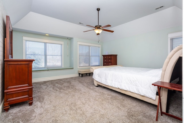 bedroom featuring ceiling fan, lofted ceiling, a raised ceiling, and carpet flooring