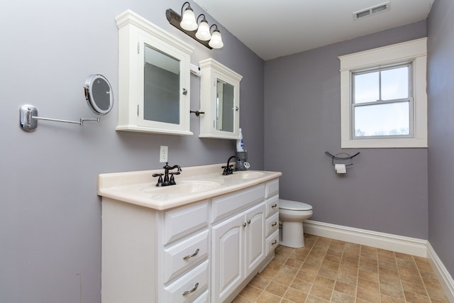 bathroom featuring toilet and vanity