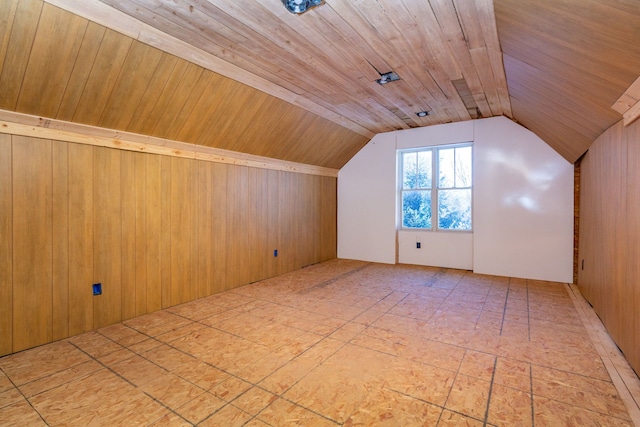 additional living space featuring wooden ceiling, lofted ceiling, and wooden walls