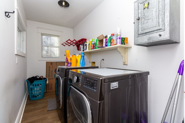 washroom featuring cabinets, washer and clothes dryer, and hardwood / wood-style floors