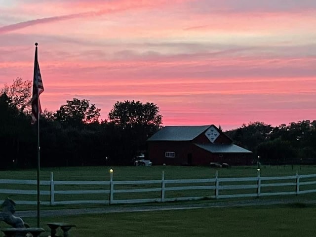 yard at dusk with a rural view