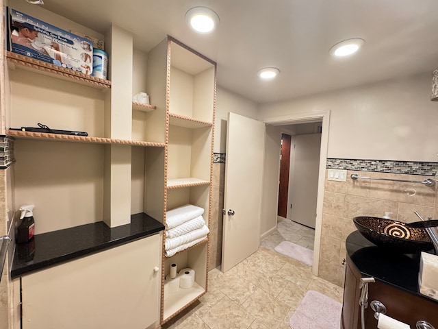 bathroom with tile walls