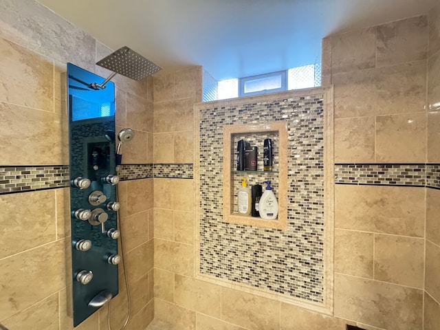 bathroom with a tile shower