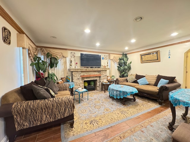 living room featuring ornamental molding and a fireplace