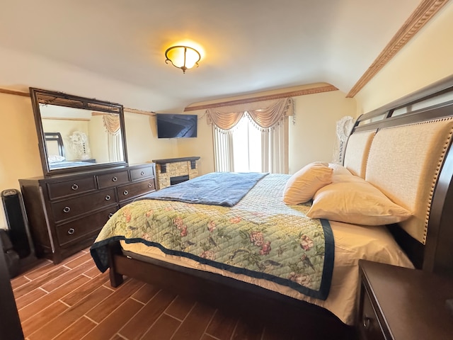 bedroom featuring crown molding and dark hardwood / wood-style floors