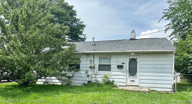 rear view of house with a yard